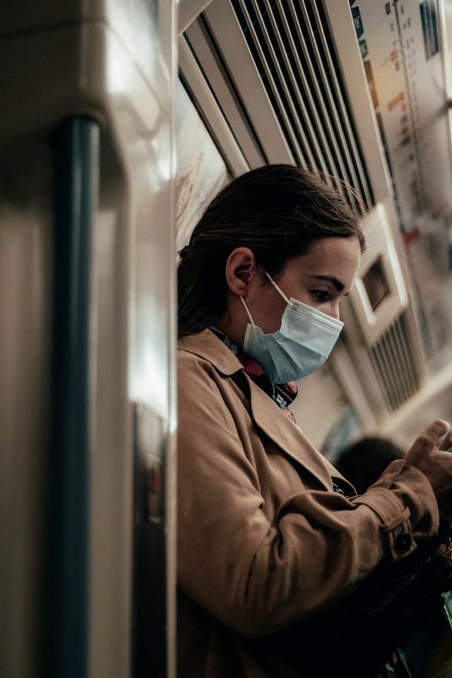 masked woman on a train